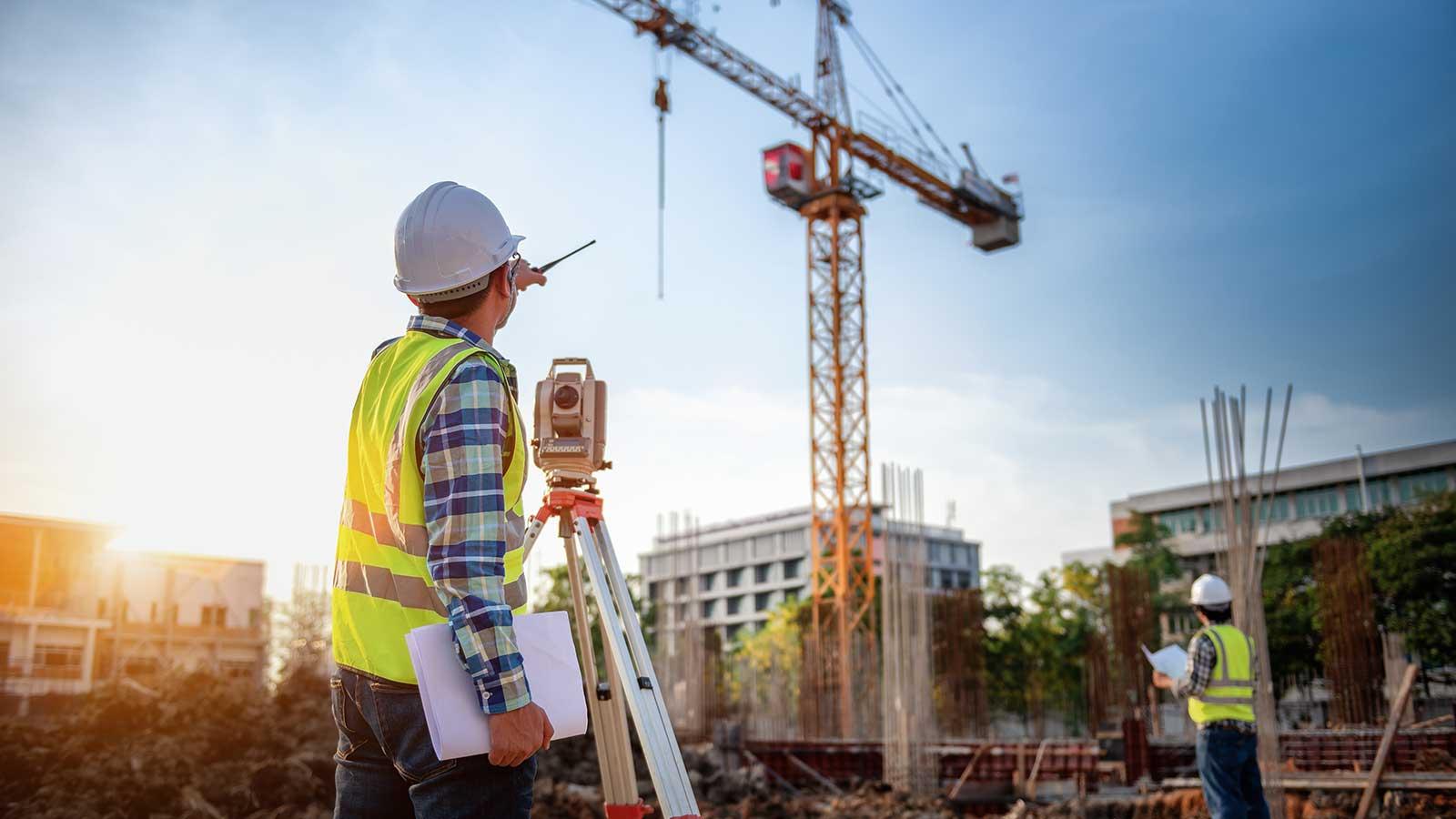 An engineering taking measurements on a construction site