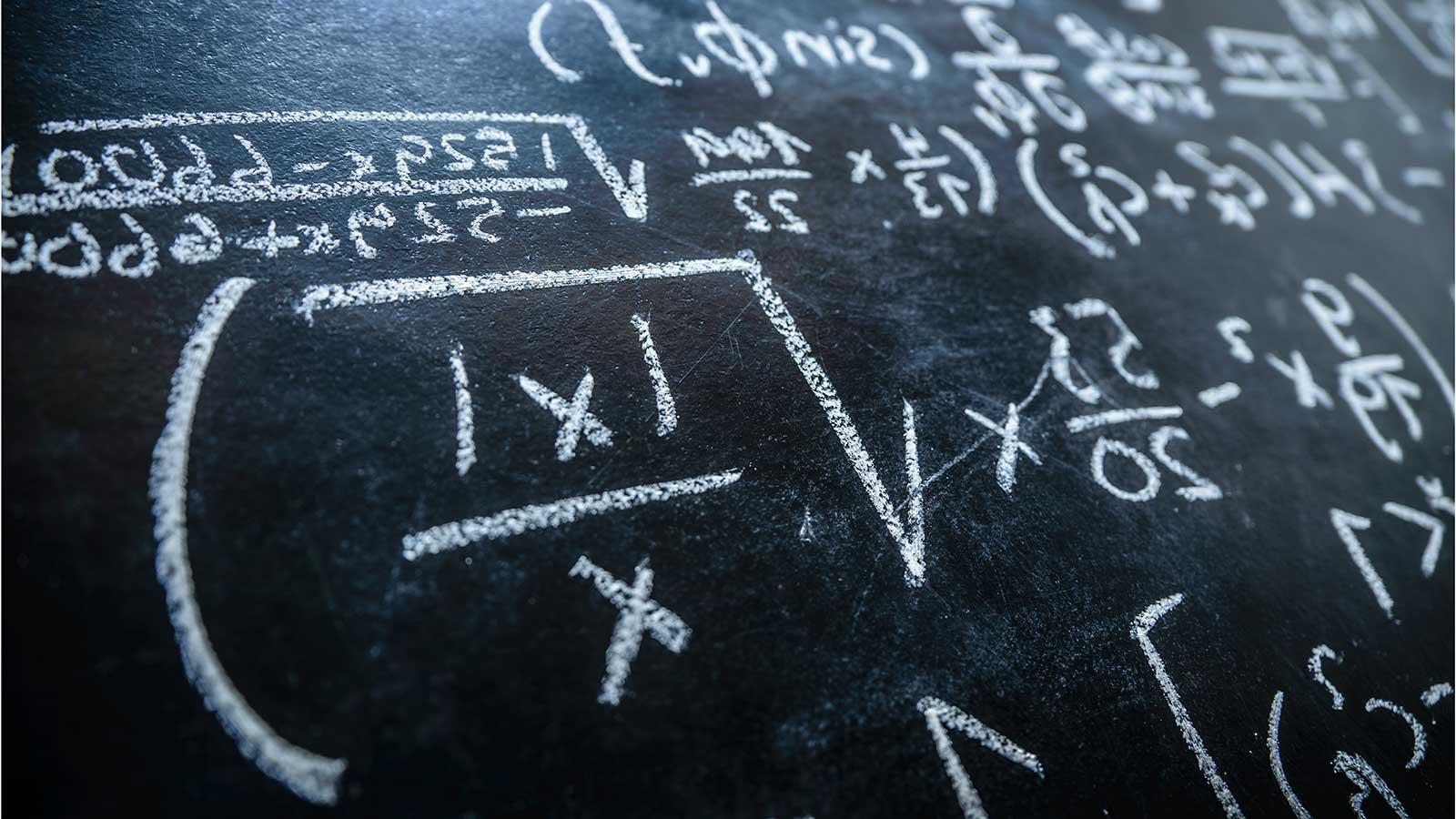 Equation on blackboard representing Applied 数学 and 统计数据 program at Clarkson