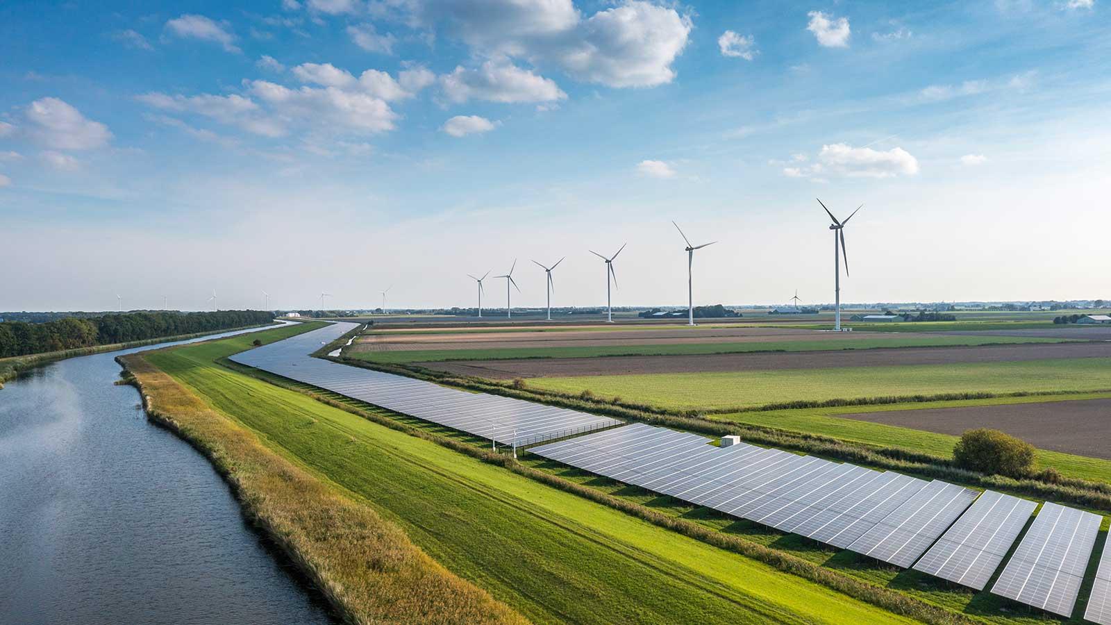 Solar panels and wind turbines representing 业务 Energy degree programs at esball国际平台客户端