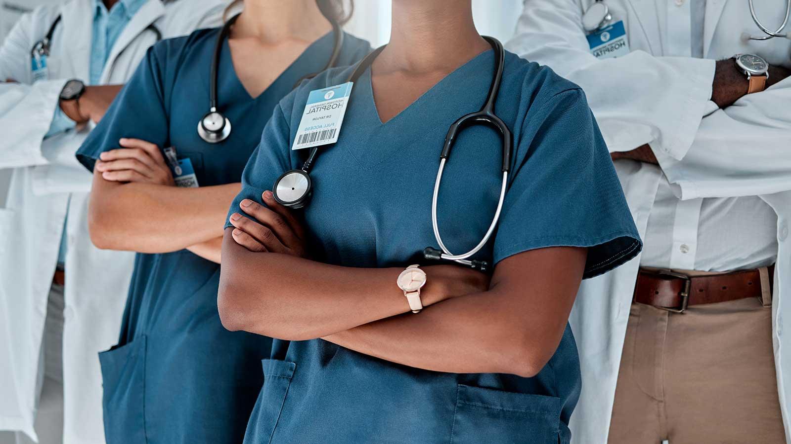 Medical professionals standing together with crossed arms